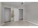 Comfortable bedroom with carpet, sliding closet doors and view to a room with hardwood flooring at 8720 W Willowbrook Dr, Peoria, AZ 85382