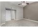 Comfortable bedroom with neutral walls, plush carpet, and view to an ensuite bathroom at 8720 W Willowbrook Dr, Peoria, AZ 85382