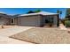 Cozy single-story home with a two-car garage, complemented by desert landscaping at 8720 W Willowbrook Dr, Peoria, AZ 85382