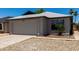 Exterior view of a one-story residence featuring a two-car garage, and desert landscaping at 8720 W Willowbrook Dr, Peoria, AZ 85382