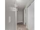 Inviting hallway with tiled floors, modern wall lighting, and closet, leading to other rooms at 8720 W Willowbrook Dr, Peoria, AZ 85382