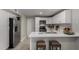 Contemporary kitchen featuring white cabinets, stainless steel appliances, and a breakfast bar at 8720 W Willowbrook Dr, Peoria, AZ 85382