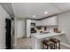 Modern kitchen featuring white cabinets, stainless steel appliances, and a breakfast bar island at 8720 W Willowbrook Dr, Peoria, AZ 85382