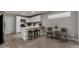 Bright kitchen featuring white cabinets, stainless steel appliances, and a breakfast bar at 8720 W Willowbrook Dr, Peoria, AZ 85382