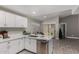 Kitchen featuring white cabinetry, stainless appliances, granite countertops, and dining space at 8720 W Willowbrook Dr, Peoria, AZ 85382