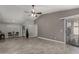 Open living room with modern tile floors, fan, and access to the kitchen and backyard at 8720 W Willowbrook Dr, Peoria, AZ 85382