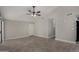 Bright living room with tile flooring, ceiling fan, and a front door entry at 8720 W Willowbrook Dr, Peoria, AZ 85382
