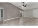 Spacious living room featuring tile floors, ceiling fan, and sliding glass door to the backyard at 8720 W Willowbrook Dr, Peoria, AZ 85382