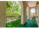Balcony with wrought iron railing offering views of mature trees at 905 S Osborn Ln, Gilbert, AZ 85296