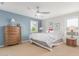 Bedroom with neutral carpet, ceiling fan and two windows bringing in natural light at 905 S Osborn Ln, Gilbert, AZ 85296