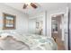 Bedroom with ceiling fan, framed art, and sliding mirrored closet doors for ample storage at 905 S Osborn Ln, Gilbert, AZ 85296