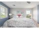 Bedroom with neutral carpet, ceiling fan and two windows bringing in natural light at 905 S Osborn Ln, Gilbert, AZ 85296