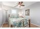 Bedroom featuring a decorative metal bed frame, ceiling fan, and natural light from the window at 905 S Osborn Ln, Gilbert, AZ 85296