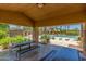 Pool cabana with multiple picnic tables, view of pool, and a peaceful place to enjoy the outdoors at 905 S Osborn Ln, Gilbert, AZ 85296