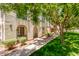 Charming home exterior showcasing a landscaped yard, covered patios, and neutral-toned walls with arched entries at 905 S Osborn Ln, Gilbert, AZ 85296