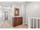 Second story hallway with carpeted floor, neutral walls and a built-in cabinet at 905 S Osborn Ln, Gilbert, AZ 85296
