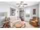 Cozy living room with a ceiling fan, bookshelf, sofa, and natural light from the window at 905 S Osborn Ln, Gilbert, AZ 85296