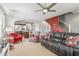 Spacious living room with neutral walls, a ceiling fan, and adjoined kitchen in the background at 905 S Osborn Ln, Gilbert, AZ 85296