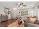 Cozy living room featuring stairs, neutral walls, hardwood floors, and ceiling fan at 905 S Osborn Ln, Gilbert, AZ 85296
