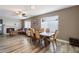 Open concept dining and living room with a fireplace, wood floors, and lots of natural light at 932 W Julie Dr, Tempe, AZ 85283
