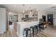Open kitchen with a breakfast bar, gray cabinetry, pendant lighting, and wood floors at 932 W Julie Dr, Tempe, AZ 85283