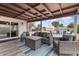 Covered patio with stylish outdoor furniture overlooking the pool and backyard at 932 W Julie Dr, Tempe, AZ 85283