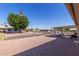 This backyard has a beautiful desert landscape, a grill and a covered patio, perfect for entertaining at 10439 W Kingswood Cir, Sun City, AZ 85351