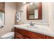 Bright bathroom features updated vanity with a framed mirror and a window at 10439 W Kingswood Cir, Sun City, AZ 85351
