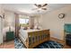Well-lit bedroom with a blue patterned rug and neutral walls for a cozy feel at 10439 W Kingswood Cir, Sun City, AZ 85351