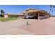 Spacious carport with decorative desert landscaping and ample parking space and driveway at 10439 W Kingswood Cir, Sun City, AZ 85351