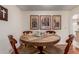 Cozy dining area featuring a unique round table and decorative wall art adding charm at 10439 W Kingswood Cir, Sun City, AZ 85351