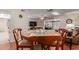 Open concept dining area with a round table, seamlessly flowing into living spaces for entertaining at 10439 W Kingswood Cir, Sun City, AZ 85351