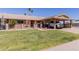 Charming single-story residence featuring covered parking, a neat front lawn, and an inviting, decorated entrance at 10439 W Kingswood Cir, Sun City, AZ 85351
