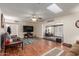 Bright living room featuring wood floors, lots of light, skylight, and inviting seating and home office at 10439 W Kingswood Cir, Sun City, AZ 85351