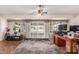 Bright living room with sliding glass doors and desk area, offering versatile living at 10439 W Kingswood Cir, Sun City, AZ 85351