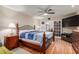 Comfortable bedroom featuring a stylish bed frame, wood floors, and a ceiling fan, creating a relaxing retreat at 10439 W Kingswood Cir, Sun City, AZ 85351