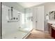 Bathroom featuring a custom shower with glass door and a white door to next room at 1229 W Sycamore Rd, Queen Creek, AZ 85140