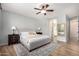 Bright bedroom with hardwood floors, neutral tones, and an en-suite bathroom at 1229 W Sycamore Rd, Queen Creek, AZ 85140