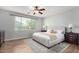 Serene bedroom with hardwood floors, a large window, and a comfortable queen-sized bed at 1229 W Sycamore Rd, Queen Creek, AZ 85140