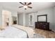 Large bedroom with hardwood floors, and a white door leading to backyard at 1229 W Sycamore Rd, Queen Creek, AZ 85140
