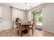 Cozy dining area adjacent to the kitchen with a glass table and sliding glass door to the backyard at 1229 W Sycamore Rd, Queen Creek, AZ 85140