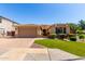 Beautiful single-story home featuring a paved driveway and manicured lawn at 1229 W Sycamore Rd, Queen Creek, AZ 85140