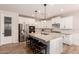 Bright kitchen featuring an island, white cabinets, stainless appliances, and a pantry at 1229 W Sycamore Rd, Queen Creek, AZ 85140