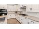 Modern kitchen with white cabinets, granite countertops, and stainless steel appliances at 1229 W Sycamore Rd, Queen Creek, AZ 85140