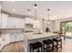 Well-equipped kitchen with an island, white cabinets, and stainless steel appliances at 1229 W Sycamore Rd, Queen Creek, AZ 85140