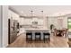 Modern kitchen with an island, stainless steel appliances, and a dining area at 1229 W Sycamore Rd, Queen Creek, AZ 85140