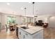 Open kitchen with island, stainless steel appliances, and view to the living room and dining area at 1229 W Sycamore Rd, Queen Creek, AZ 85140