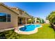 Backyard pool with lush, manicured landscaping, and access to the covered patio and home at 1229 W Sycamore Rd, Queen Creek, AZ 85140