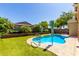 Backyard swimming pool with a safety handrail surrounded by lush landscaping, ideal for summer fun at 1229 W Sycamore Rd, Queen Creek, AZ 85140