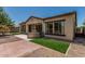 Backyard view showing the patio, turf, stucco, and tiled roofing at 12360 W Eagle Ridge Ln, Peoria, AZ 85383